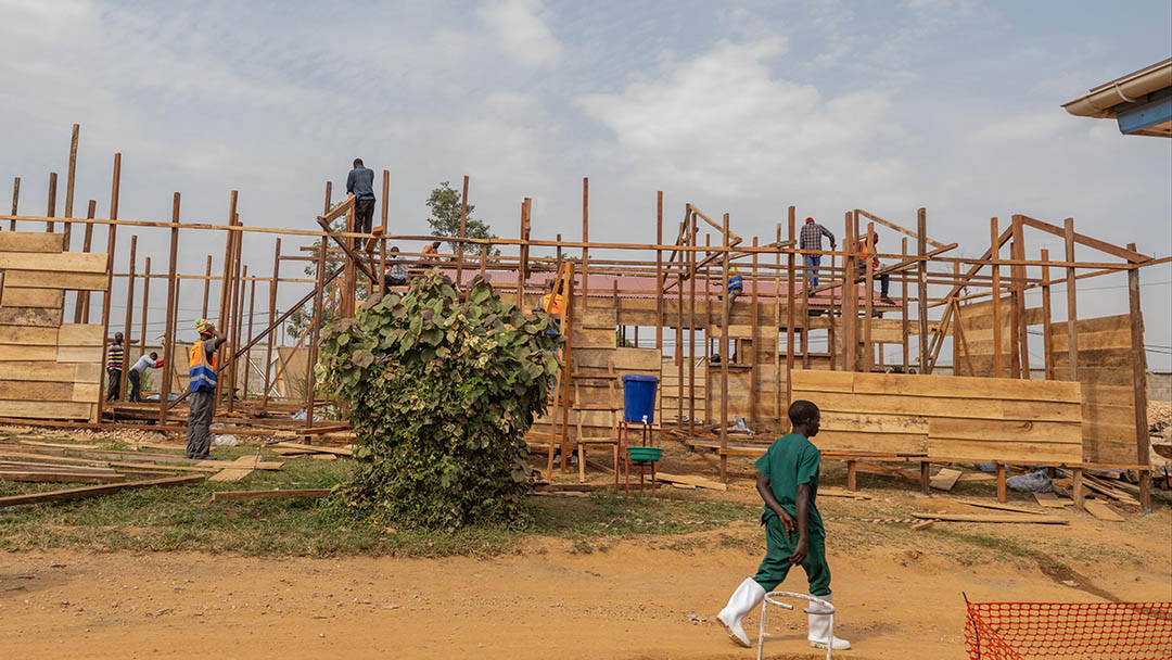 A health worker walks past a treatment center under construction at the General Hospital in Bunia, Congo, Monday, June 15, 2026. (AP Photo/Moses Sawasawa) (A health worker walks past a treatment center under construction at the General Hospital in Bun